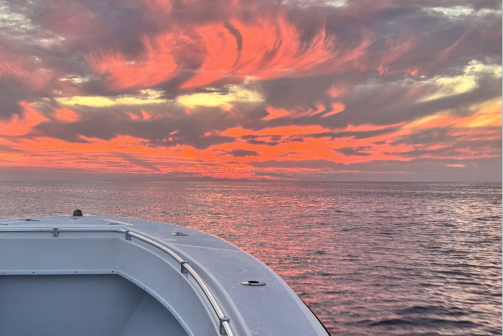 A wispy red and orange sunrise with SeaCo Fishing Charters while heading to go deep sea fishing in St. Augustine, Florida